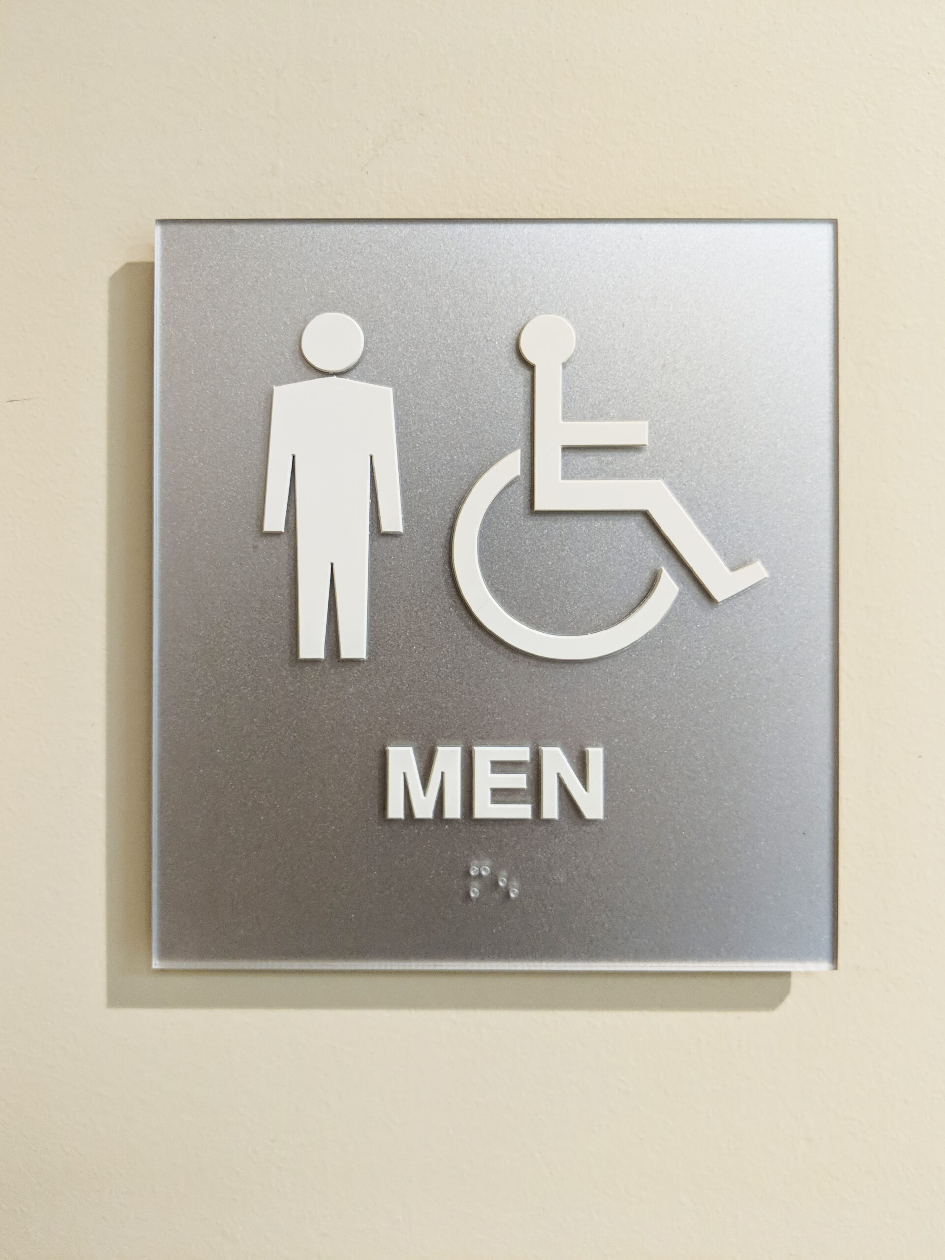 A Mens ADA accessible bathroom sign with braille and RE pictograms. Subsurface painted and part of isign's vibrant series