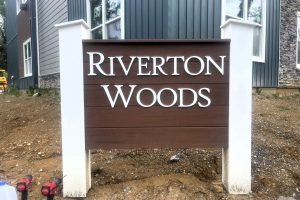 3d three dimensional solid flat cut letters of on a post and Panel monument sign